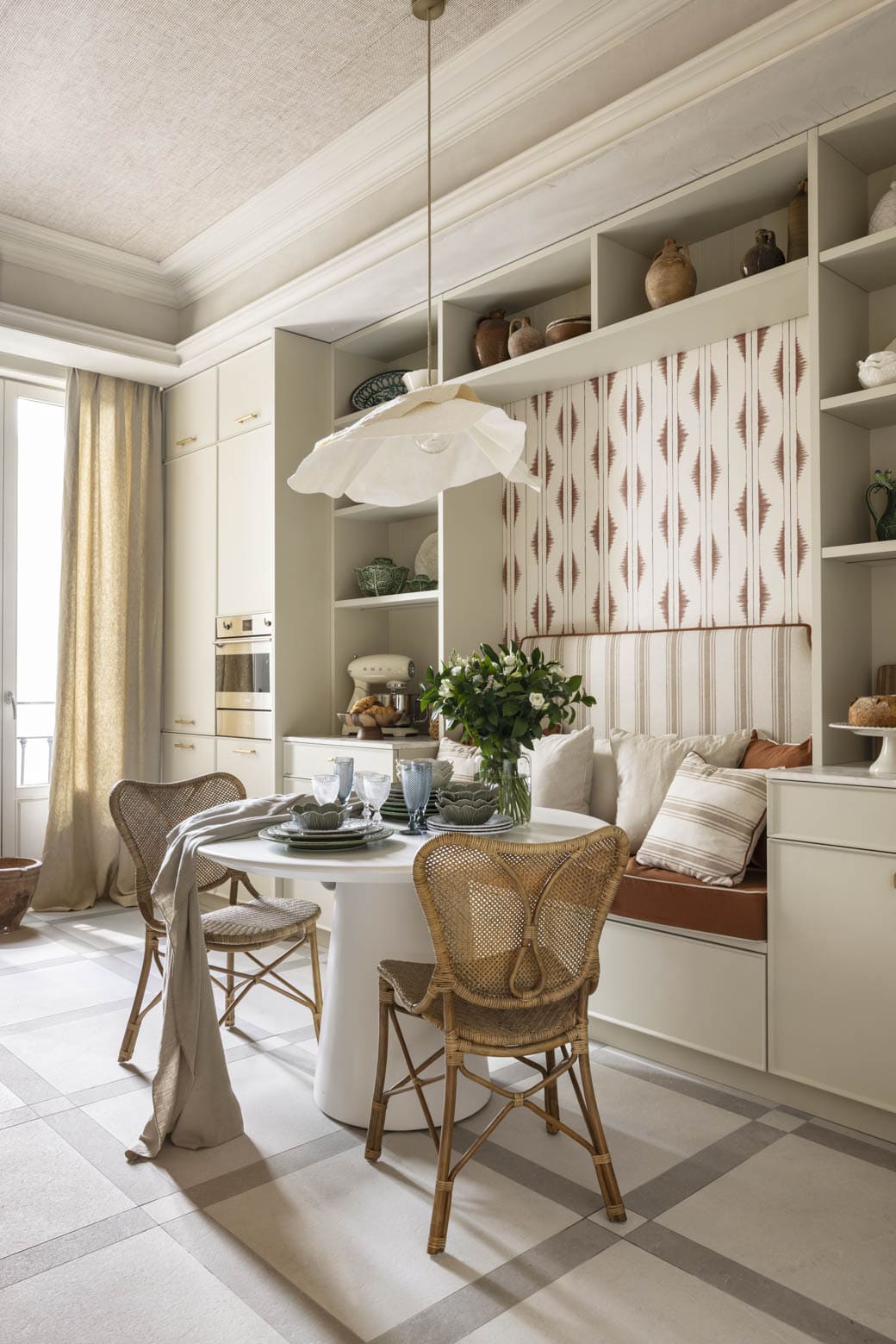 Cocina contemporánea con mesa redonda y sillas de mimbre