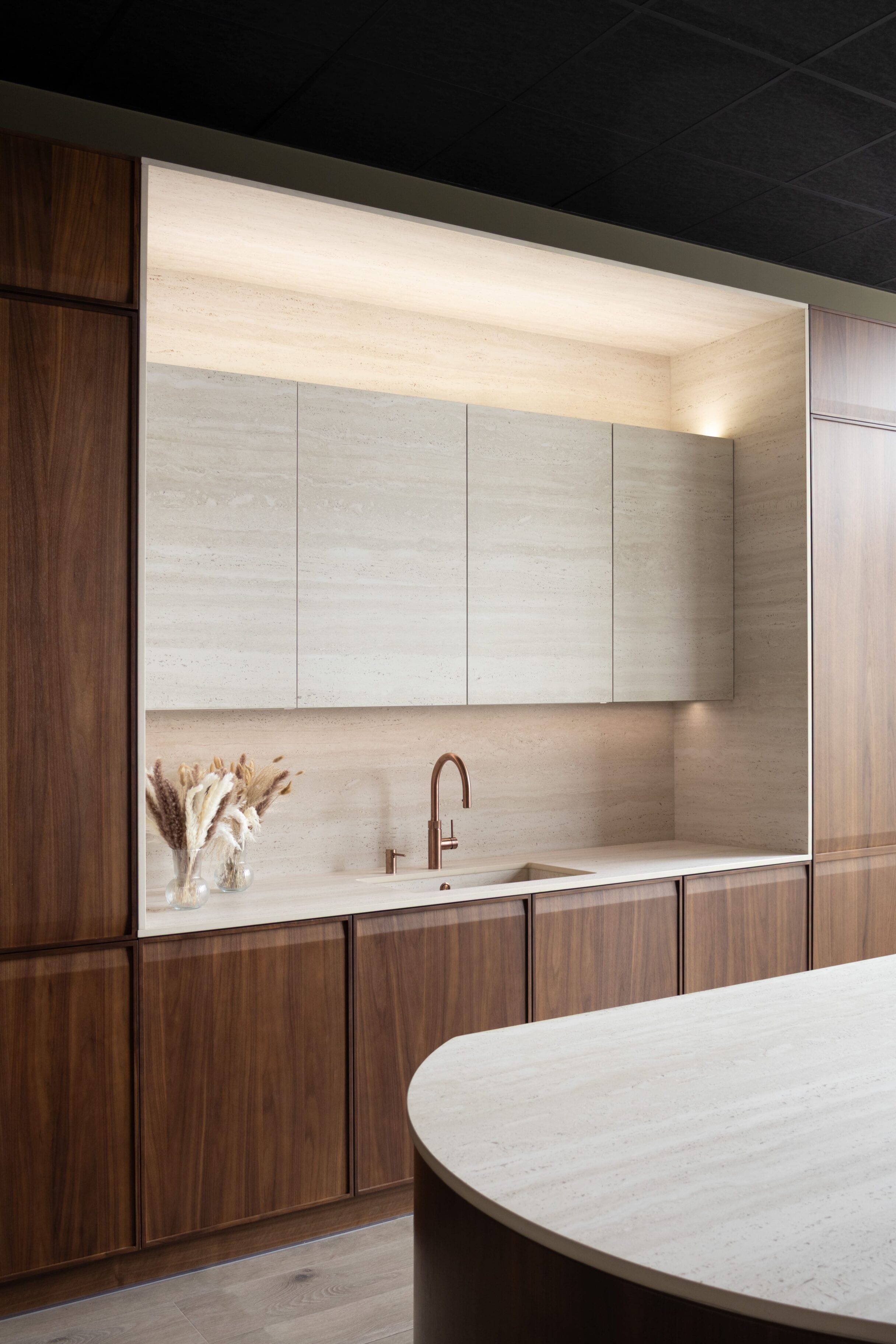 Cocina contemporánea con muebles de madera y encimera clara
